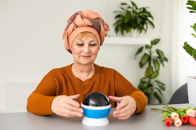 Female Fortuneteller or esoteric Oracle, sees in the future by looking into their crystal ball during a Seance to interpret them and to answer questions.