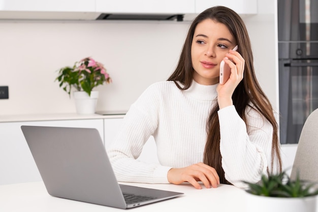 Female freelancer calls to friend on smartphone discussing life at break young woman talks on phone