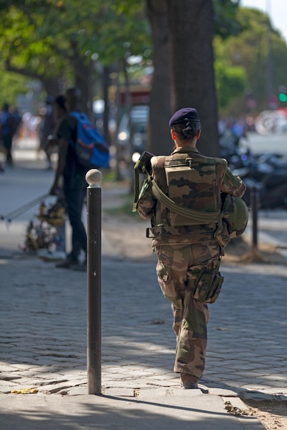 Female French soldier patrolling at the Eiffel Tower