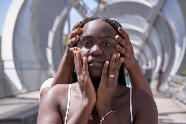 Female friends covering eyes of African merican woman