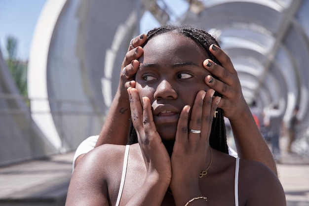 Female friends covering eyes of African merican woman