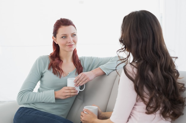 female friends enjoying a chat over coffee at home