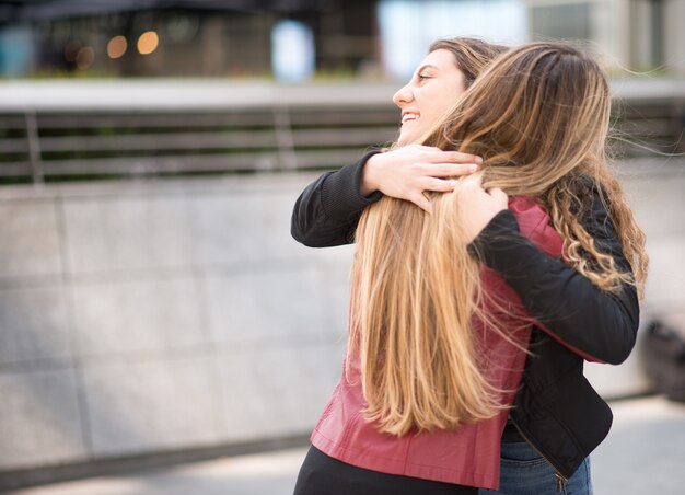 Female friends meeting in a city