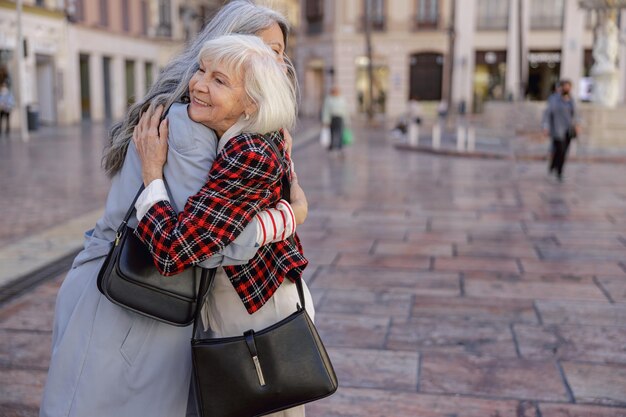 Female friends spending time at city street