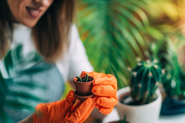 Female Gardener Holding a Potted Plant