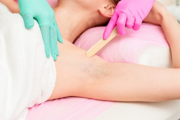 Female getting waxing armpit.