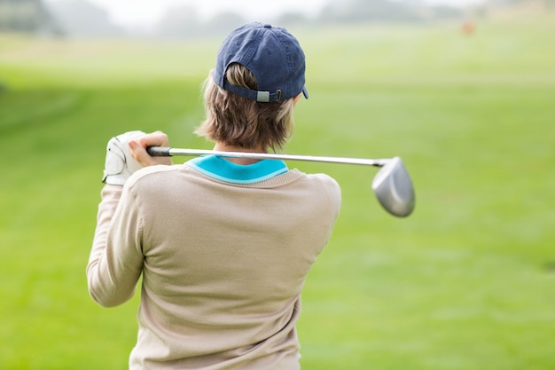 Female golfer taking a shot 