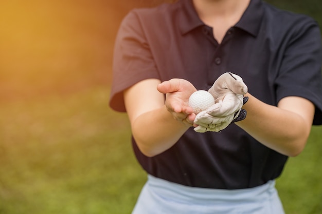 The female golfers give the golf ball.