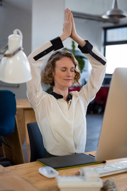 Female graphic designer performing yoga