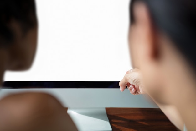 Female graphic designer pointing to desktop pc