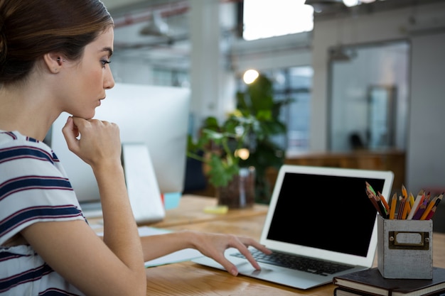 Female graphic designer using laptop