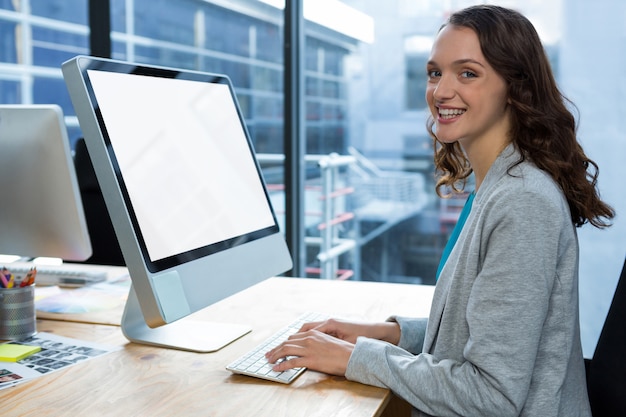 Female graphic designer working over computer at desk