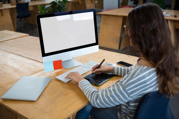 Female graphic designer working at desk