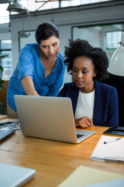 Female graphic designers using laptop