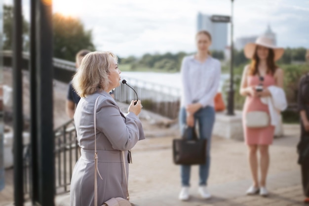 Female guide communicates with a group of tourists