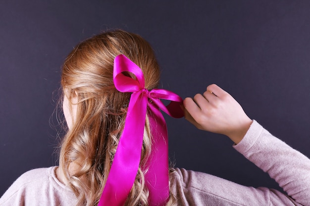 Female hairstyle with color ribbon