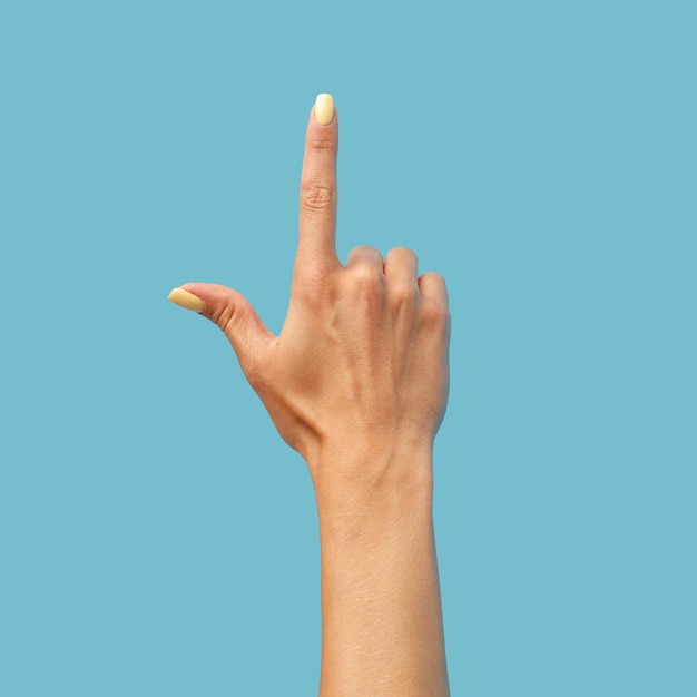 Photo female hand on a blue background in various positions