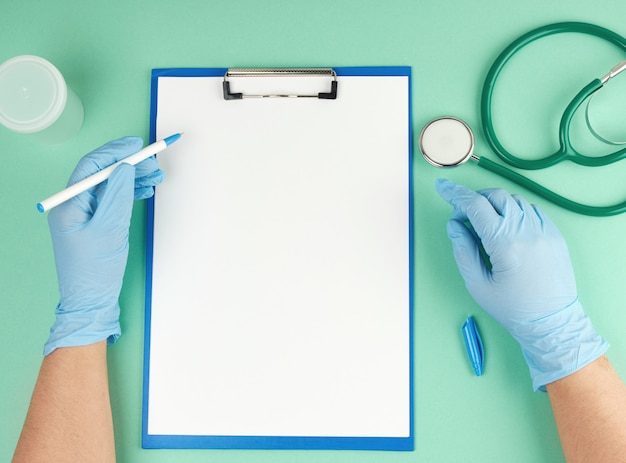 Female hand in blue sterile gloves and medical stethoscope,