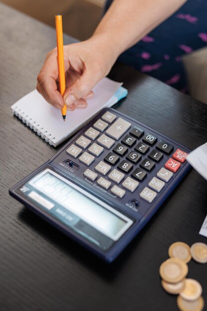 Female hand Calculate coin with notepad Financial concept Concept of accounting