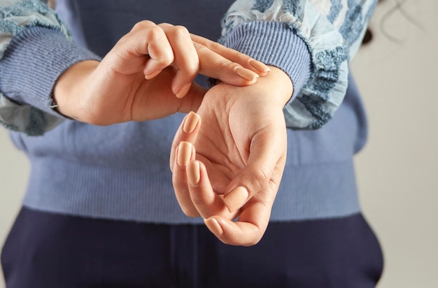 Female hand checking pulse