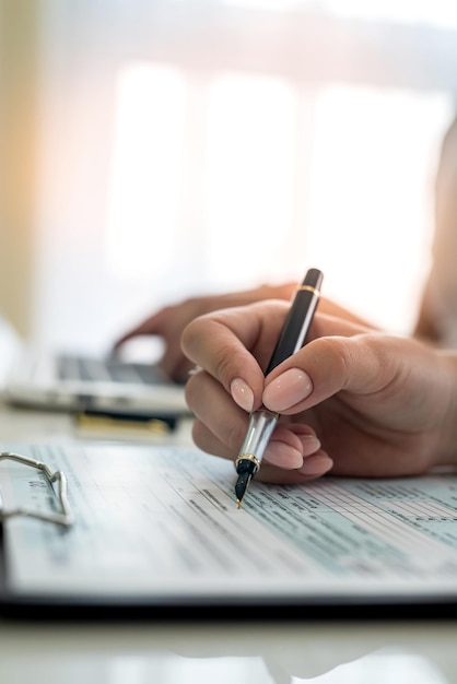 Female hand filling us tax form 1040