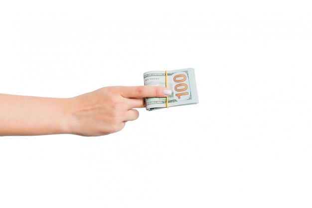 Female hand giving a bundle of dollar bills on white isolated