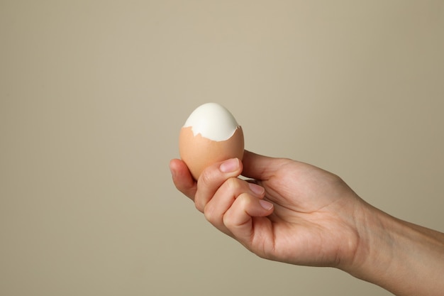 Female hand hold boiled egg