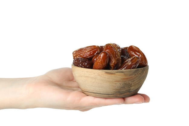 Female hand hold bowl of dried date, isolated on white background