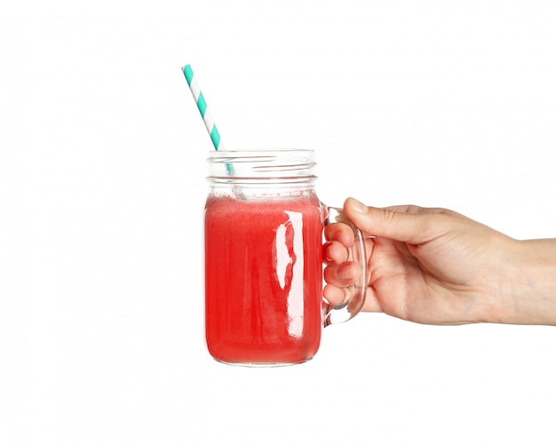 Female hand hold glass jar of watermelon juice, isolated on white space