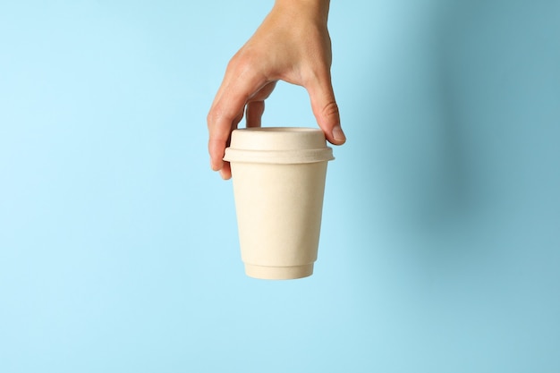 Female hand hold paper cup of coffee