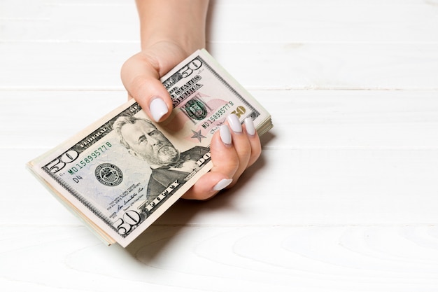 Female hand holding a bundle of money