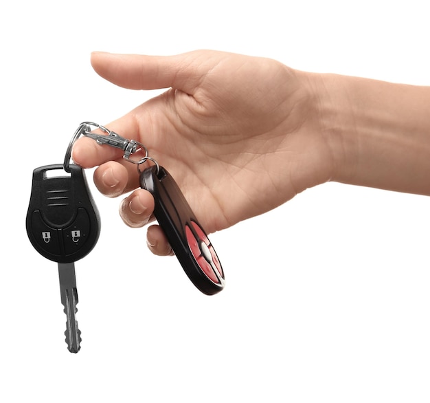 Female hand holding car keys on white background