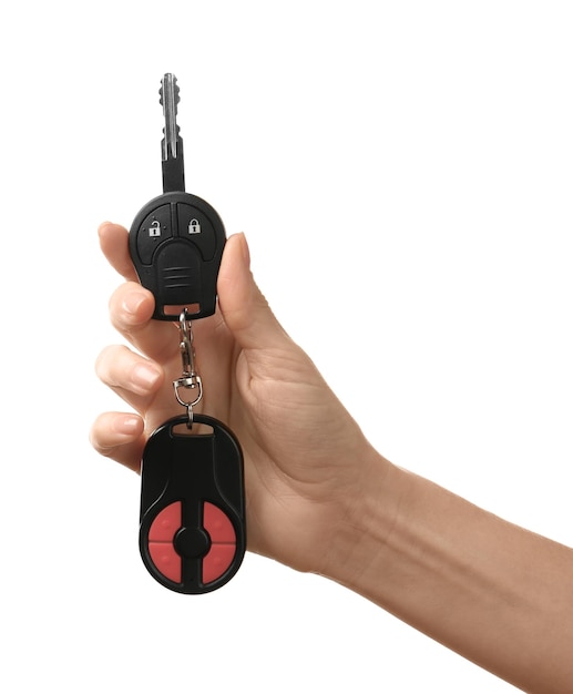 Female hand holding car keys on white background