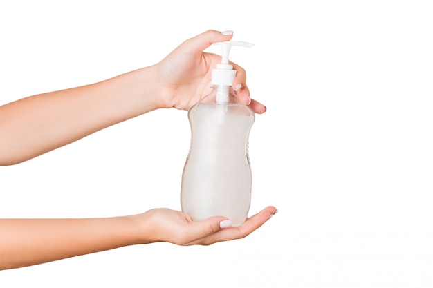 Female hand holding cream bottle