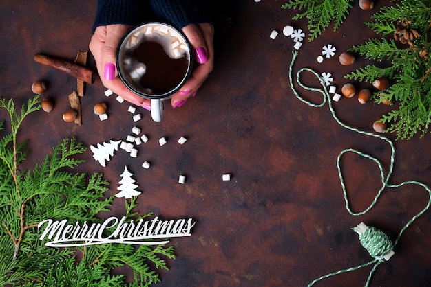 Mano femminile che tiene tazza di cacao caldo