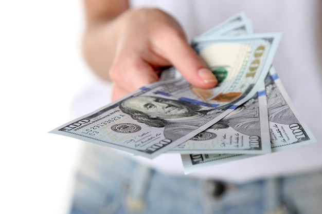 Female hand holding dollars closeup