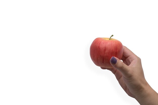 Photo female hand holding fresh apple isolated on white background with copy space