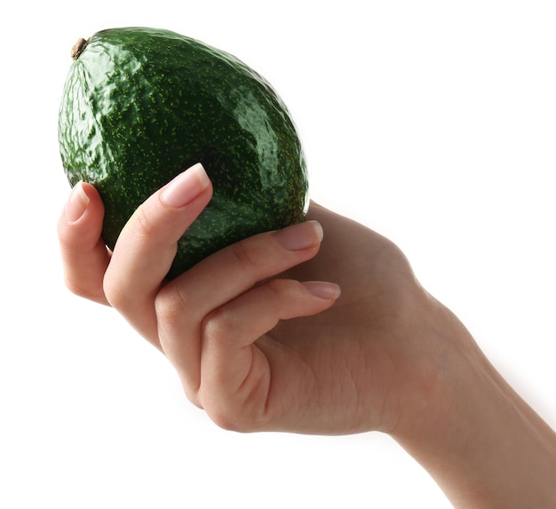 Female hand holding fresh avocado isolated on white