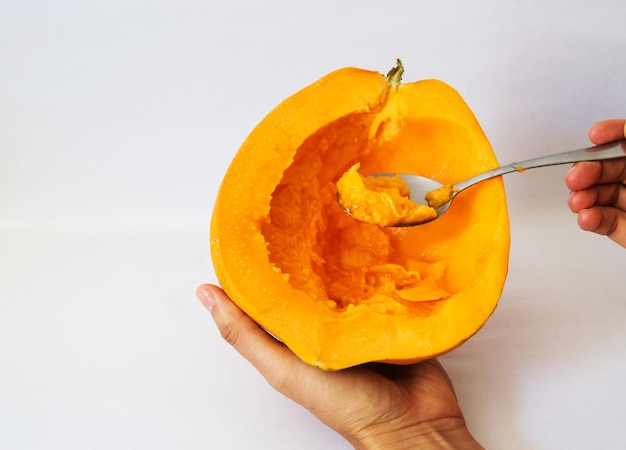 Female hand holding half of a papaya