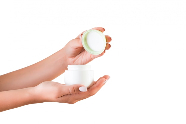 Female hand holding lotion cream