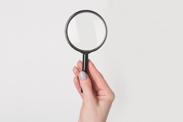 Photo female hand holding magnifier isolate