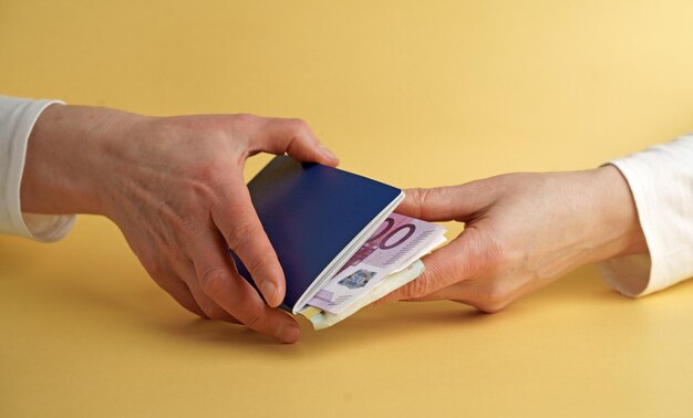 Female hand holding a passport with Euro banknotes Vacation in Europe