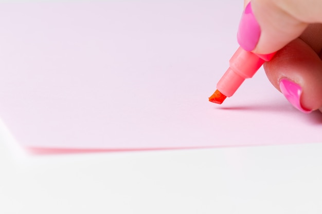 Female hand holding a pen close up