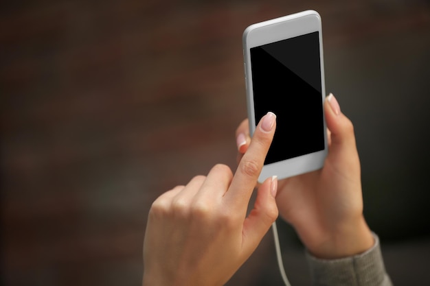 Female hand holding smartphone closeup