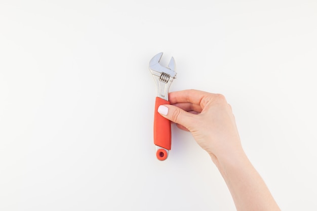 Female hand holding spanner