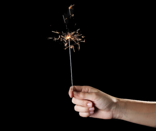 Female hand holding sparkler