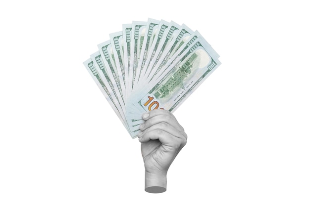 Female hand holding a wad of hundred-dollar cash bills isolated on a white background