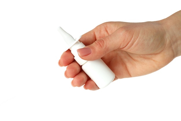 Female hand holds blank bottle of nasal spray, isolated on white background