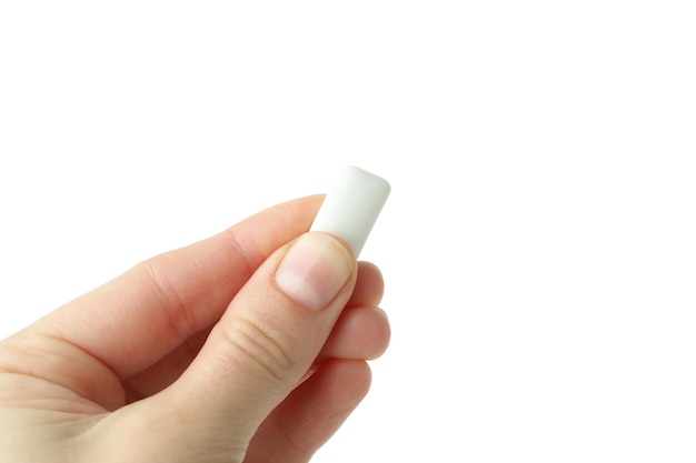 Female hand holds chewing gum isolated on white background