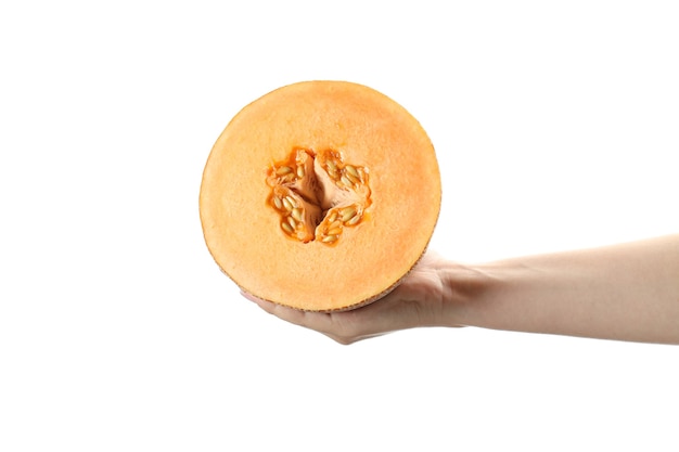 Female hand holds half of melon, isolated on white background